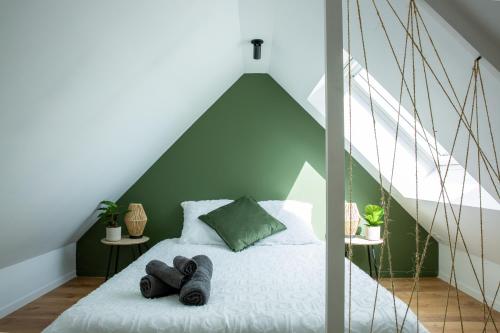 Un pat sau paturi într-o cameră la Jungle Urbaine