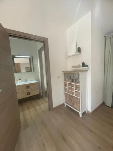 a bathroom with a sink and a mirror at Sophie Home - Comfort e Relax a pochi km da Nora in Pula
