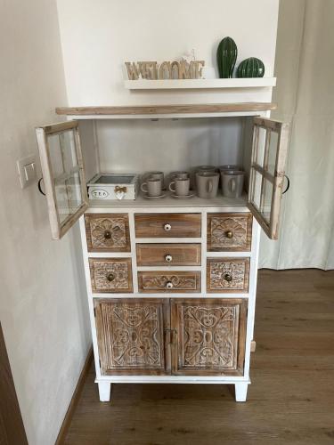 a wooden dresser with pots on top of it at Sophie Home - Comfort e Relax a pochi km da Nora in Pula