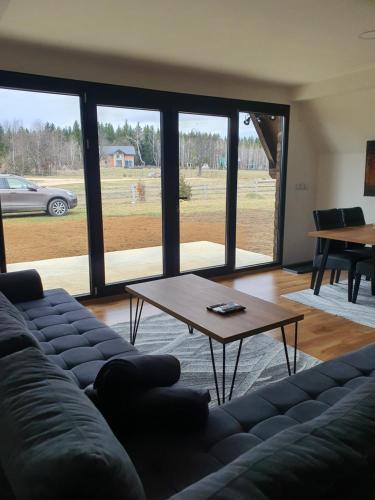 a living room with a couch and a coffee table at Kucica Hrasno in Breza