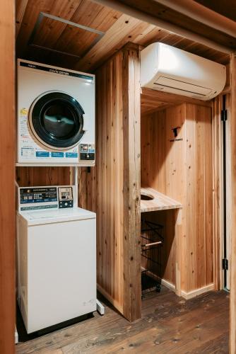 a washer and dryer in a tiny house at Ikeda Ryokan - Vacation STAY 79302v in Nishinoomote