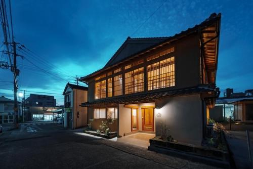 a large building with windows on the side of a street at Ikeda Ryokan - Vacation STAY 79302v in Nishinoomote