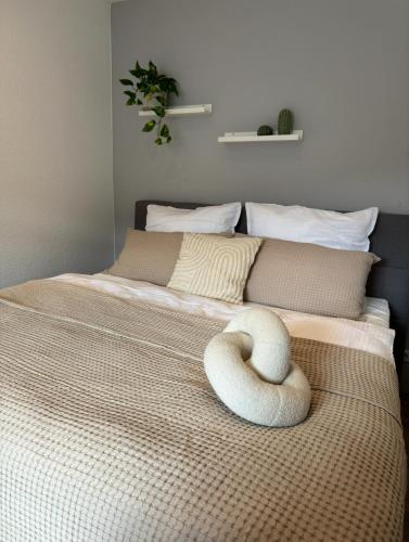a room with a bed with a swan pillow on it at NORA One in Traben-Trarbach