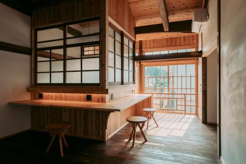 a room with a counter and two stools and a window at Ikeda Ryokan - Vacation STAY 79239v in Nishinoomote