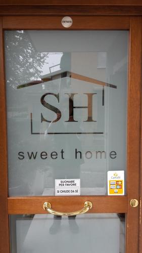 a glass door with a sign for a sweet home at Sweet Home in Treviso