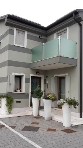 a building with white pots of plants in front of it at Sweet Home in Treviso