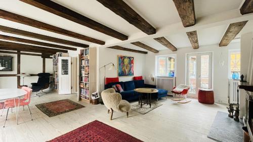 a living room with a blue couch and a table at ApartmentInCopenhagen Apartment 1631 in Copenhagen