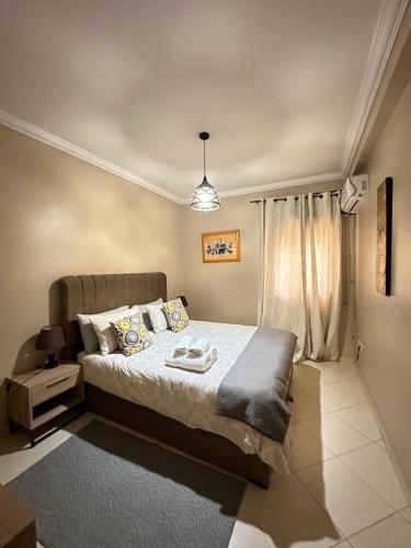um quarto com uma cama grande e uma janela em Marina apartment em Tânger