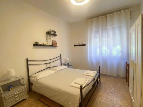 sypialnia z łóżkiem i oknem w obiekcie Ad Agio Apartments w Pizie