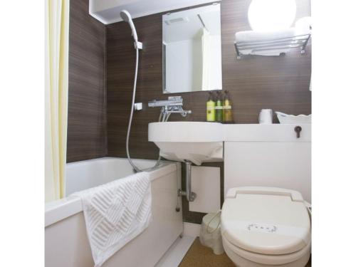 a bathroom with a sink and a toilet and a tub at Hotel Tetora Tsurumi - Vacation STAY 37288v in Yokohama