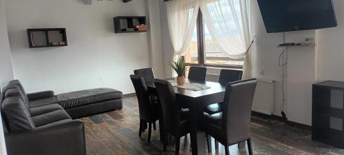a living room with a table and chairs and a couch at Popasul de Wis in Moieciu de Jos
