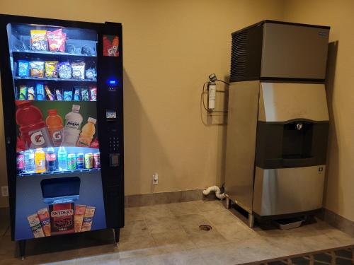 a refrigerator with its door open next to a soda at Cotulla Whitten Inn in Cotulla