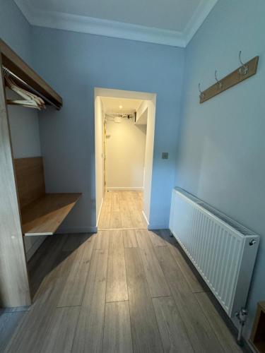a hallway with blue walls and wooden floors at Hamilton Court Hotel Hoole in Chester