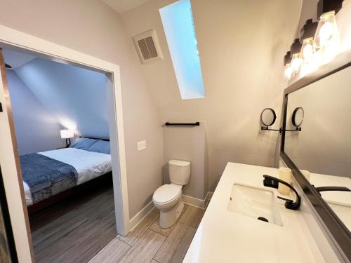 a bathroom with a sink and a toilet and a bed at Lakefront Keowee Luxury Cottages 127 in Seneca
