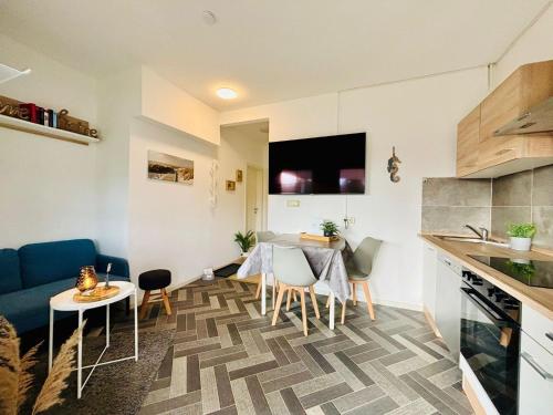 a kitchen and a living room with a table and chairs at Ostsee Ferienhaus Usedom Familie Stopp Haus 26 in Lütow