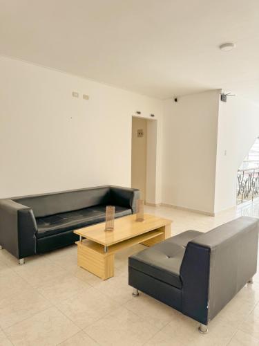 a living room with a couch and a coffee table at Hotel Ginebra Sincelejo in Sincelejo