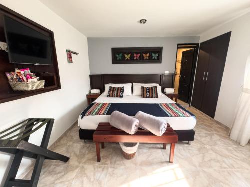 a bedroom with a bed and a table and a tv at Tierra Maravilla in Salento