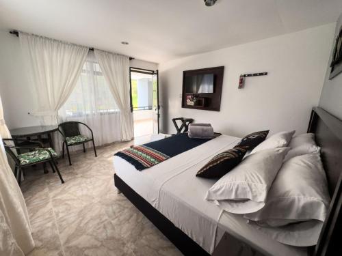 a bedroom with a bed with pillows and a desk at Tierra Maravilla in Salento