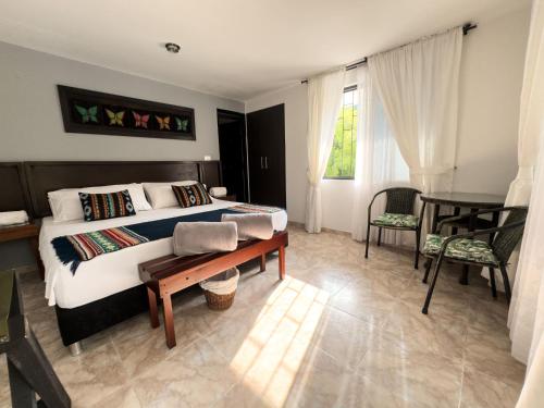 a bedroom with a bed and a table and a piano at Tierra Maravilla in Salento