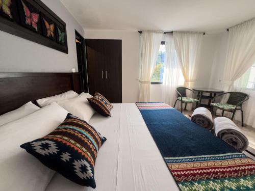 a white bed with pillows on it in a bedroom at Tierra Maravilla in Salento