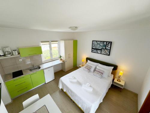 a small bedroom with a bed and a kitchen at Hvar Sunny hill in Hvar