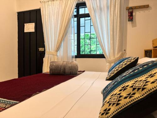 a bedroom with a large bed with a window at Tierra Maravilla in Salento