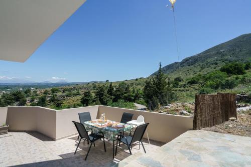a table and chairs on a patio with a view at Patima Hills in Chania Town