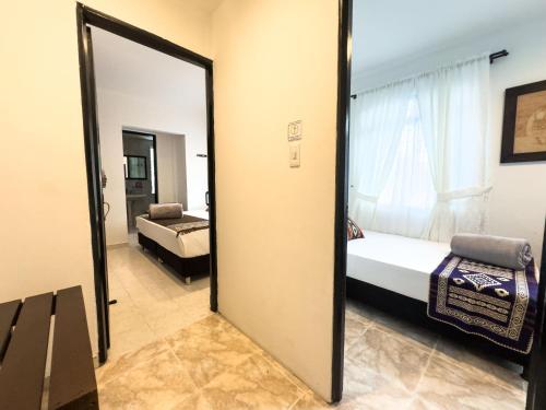 a mirror in a room with a bed and a bedroom at Tierra Maravilla in Salento