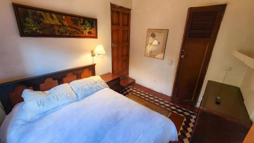 a bedroom with a large bed in a room at Casa Carmelita Hotel Boutique Pitalito in Pitalito