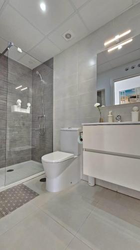 a bathroom with a shower and a toilet and a sink at Mamba Beach II in Calpe