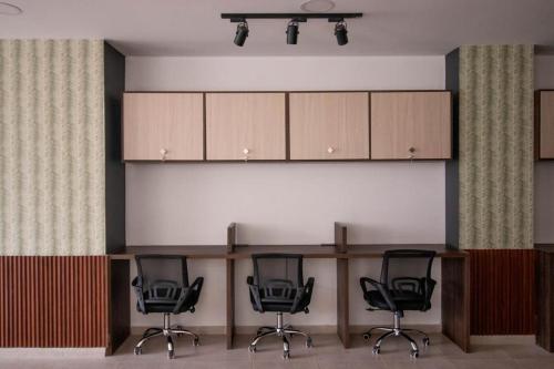 a room with four chairs and a counter with cabinets at HOTEL CALIFORNIA in Pitalito