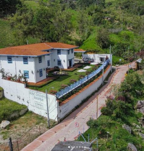 a train is parked next to some white buildings at Hotel Concepción Antioquia in Concepción