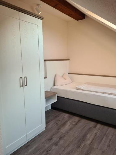 a bedroom with a bed and a cupboard at Gasthuus Ulenhoff in Westoverledingen