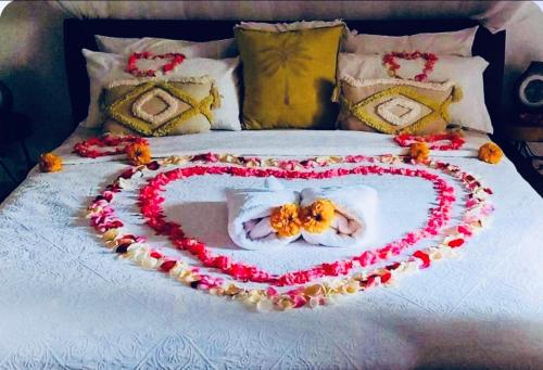 a heart made out of flowers on a bed at Luka Villas - Luxury 2 Bedroom Private Pool Villa in Seminyak