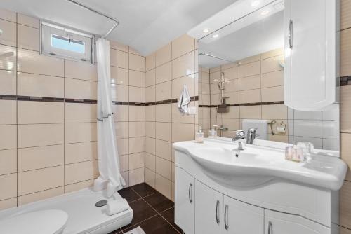 a bathroom with a sink and a toilet and a mirror at Alba Sanja i Teran in Funtana