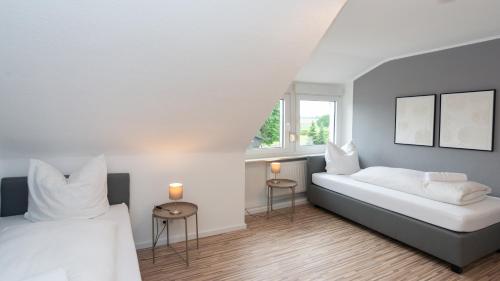 ein Schlafzimmer mit zwei Betten und einem Fenster in der Unterkunft ERSTAY - moderne Zimmer in Dorsten