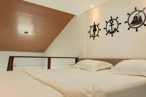 a bedroom with two beds with anchors on the wall at SUNNY HALL Porto de galinhas in Porto De Galinhas