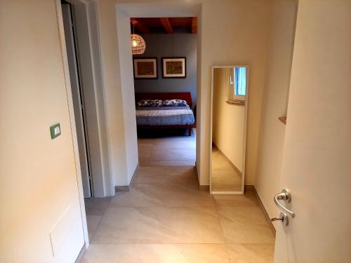 a hallway leading to a bedroom with a bed at B&B La dolce Vite in Medea