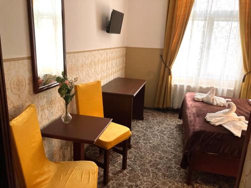 a hotel room with a bed and a table and chairs at Hotel Liliova Prague Old Town in Prague