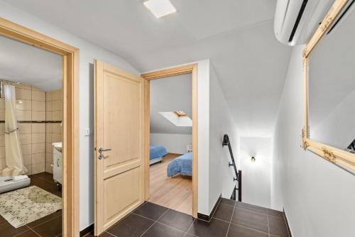 a hallway with a door to a bathroom with a bed at Alba Sanja i Teran in Funtana