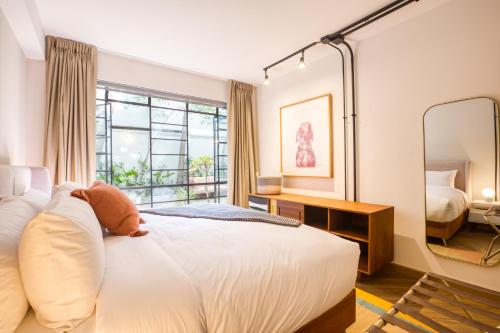 a bedroom with a bed with a teddy bear on it at Casa Miravalle in Mexico City