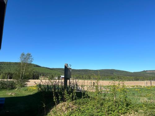 a sign on the side of a field with a fence at Annas B&B in Järvsö