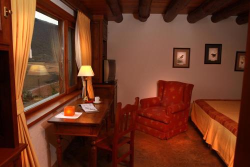 a bedroom with a bed and a desk and a chair at Piedra Pintada in Aluminé