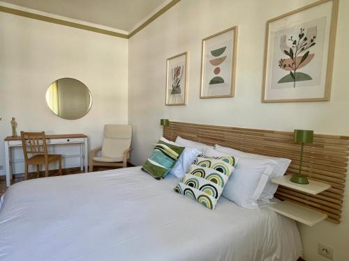 a bedroom with a large white bed with pillows at Casa Margherita (Alba) in Alba
