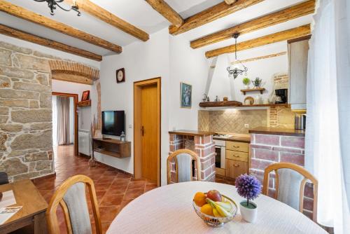 a kitchen with a table with a bowl of fruit on it at Apartment Alba in Funtana