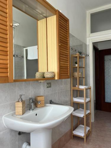 a bathroom with a sink and a mirror at Casa Margherita (Alba) in Alba