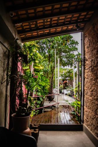 an open door to a patio with a bunch of plants at Cas'Amazonia Brasil in Belém