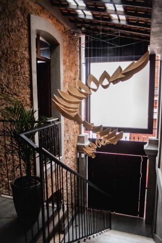 a group of wooden umbrellas hanging from a building at Cas'Amazonia Brasil in Belém