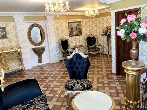 a room with chairs and a table and a mirror at Hotel Liliova Prague Old Town in Prague