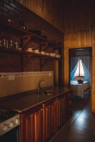 a kitchen with a sink and a view of a boat at Cabañas San Valentín in Eldorado